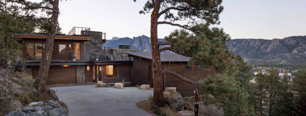 Exterior of luxury home with mountains in the backgrond